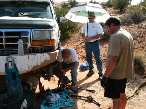 1990 Ford Bronco - Chris replaces a wheel joint that spit out two caps on Golden Spike. Doug (holding the umbrella) prepares to serve tea and crumpets ;)