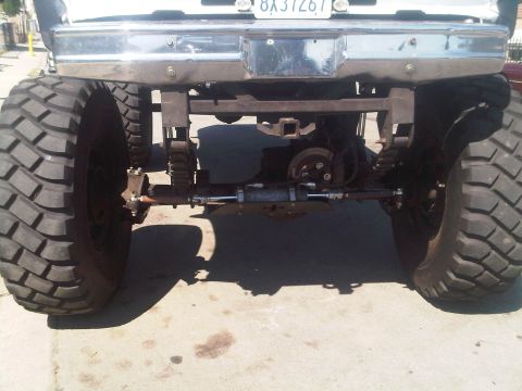 1986 Ford Bronco - Modified truck rear axle and suspension with oversized tires and a chrome bumper.