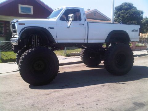 1986 Ford Bronco - This lifted Ford pickup truck has massive tires and a high suspension.