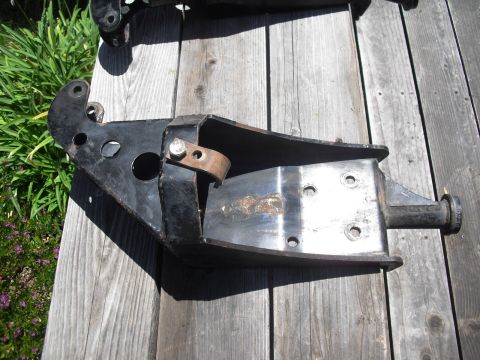 1986 Ford Bronco - This is a custom fabricated coil bucket assembly, likely for off-road modification, shown on a wooden surface.