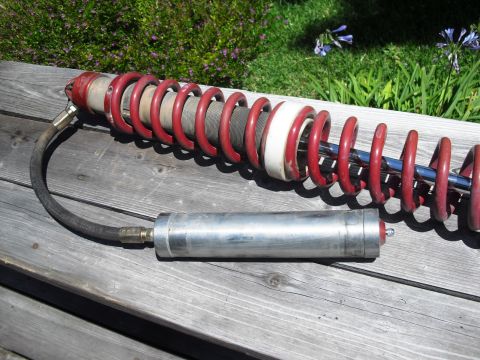 1986 Ford Bronco - A single coilover shock absorber with a remote reservoir is shown, not a 1986 Ford Bronco.