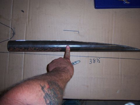 1996 Ford Bronco - A metal tube is measured on a piece of cardboard, with markings indicating its length.