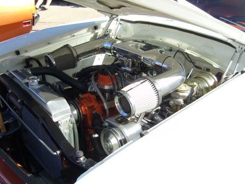 2007 Ford Mustang - Engine bay of a white car with custom chrome intake pipes and an orange engine block.