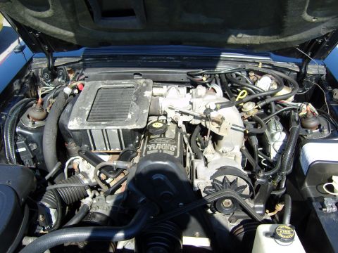 2007 Ford Mustang - The engine bay of a Ford vehicle, a 2.3L Turbo engine with visible intercooler and fuel injection components.