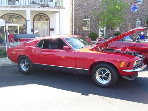 2007 Ford Mustang - A red 1970 Ford Mustang Mach 1 is parked outside with its hood open, displaying the engine.