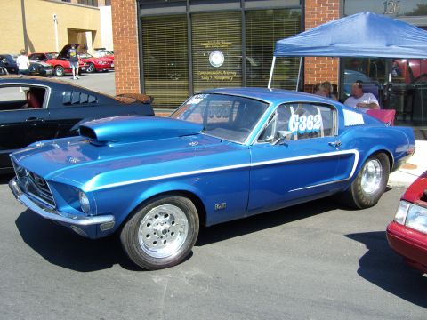 2007 Ford Mustang - Modified 1967-1968 Ford Mustang fastback drag car parked outdoors with other vehicles.
