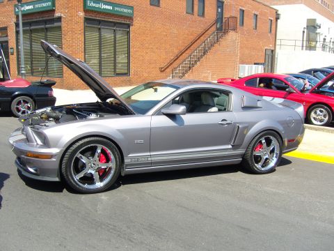 2007 Ford Mustang - A gray 2007 Ford Mustang GT350 is parked with its hood open, its engine and red brake calipers.