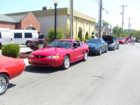 2007 Ford Mustang - A red 1996 Ford Mustang is parked on a street with other vehicles visible.