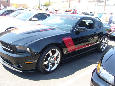 2007 Ford Mustang - Black 2007 Ford Mustang parked at a car show, custom racing stripes and decals.
