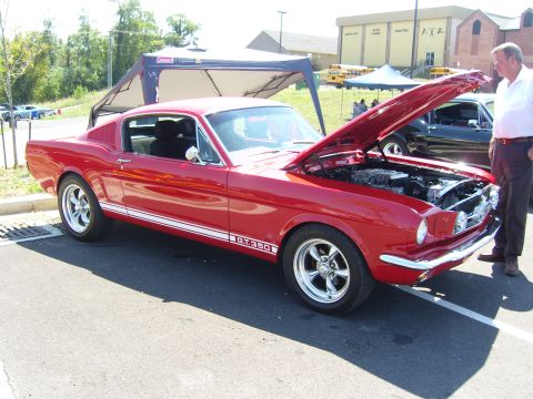 2007 Ford Mustang - A classic red 1965 Ford Mustang GT350 is displayed with its hood open at an outdoor event.