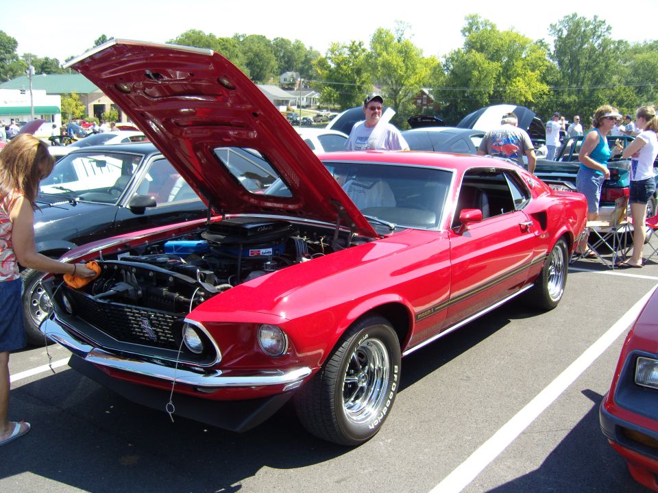Red 1969 Ford Mustang Mach 1 with hood open, BFGoodrich tires