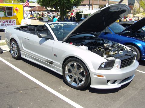 2007 Ford Mustang - A silver Saleen convertible is displayed with its hood open at an outdoor event, with another car visible behind it.