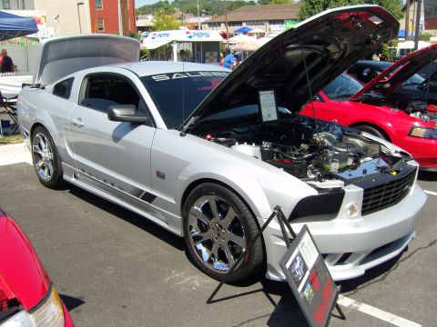 2007 Ford Mustang - A silver 2007 Ford Mustang Saleen is displayed with its hood open, revealing the engine compartment.
