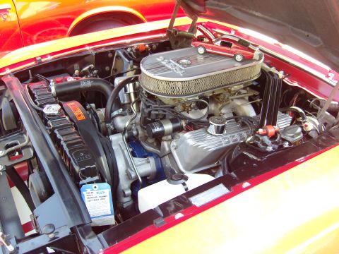 2007 Ford Mustang - Engine bay of a classic Ford Mustang, with a miniature model of the car placed on top of the air filter assembly.