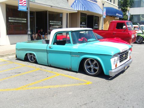 2007 Ford Mustang - Customized Dodge pickup truck parked on a street with other vehicles visible.