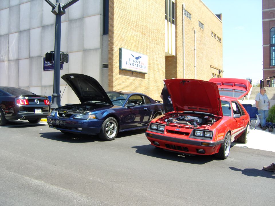 Red 1985 Ford Mustang front view with hood open