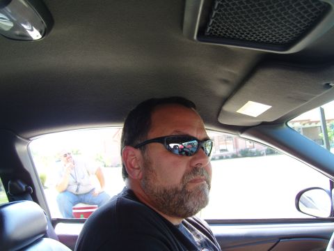 2007 Ford Mustang - Two men inside a car, one in the driver's seat and another in the background.