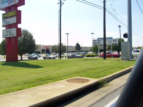 2007 Ford Mustang - Multiple Ford Mustangs are seen driving in a parking lot on a clear day.