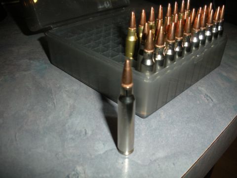 1996 Ford Bronco - Ammunition is displayed in a plastic case, with a single bullet positioned in front of it.