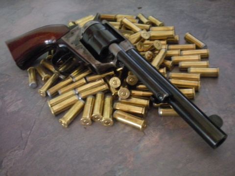 1996 Ford Bronco - A firearm and ammunition are displayed on a textured surface.