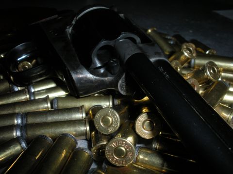 1996 Ford Bronco - A close-up view of a revolver cylinder resting on a pile of .38 Special ammunition.