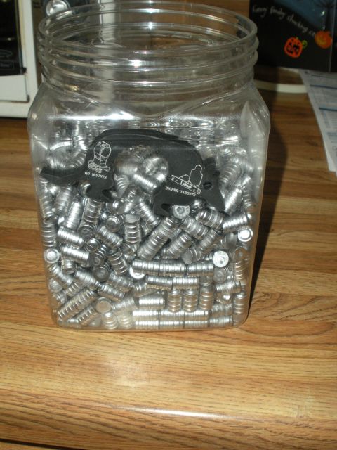 1996 Ford Bronco - Jar of bullets and target holders, likely for shooting practice.