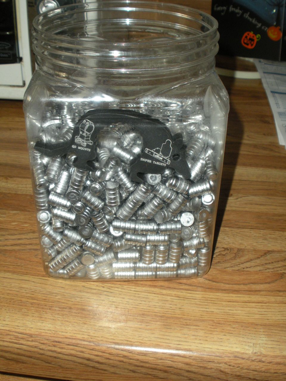 Jar filled with bullets and two black target holders with text 'GO MOUNTS' and 'SNIPER TARGETS'