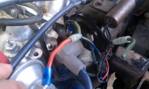 1978 Ford Bronco - Close-up view of an engine's ignition system, showing distributor cap and wiring.