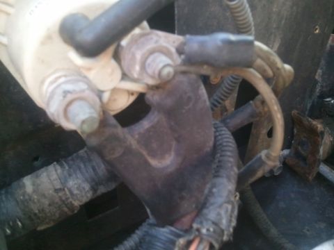 1994 Ford Bronco - Engine component with attached wiring and hoses, likely part of a larger system.