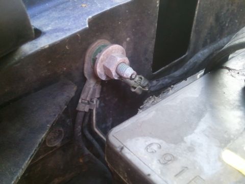 1994 Ford Bronco - Close-up of a corroded battery terminal connection with visible rust and wiring.