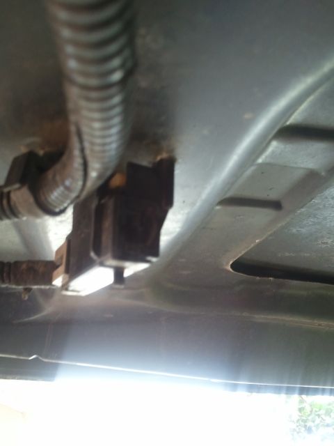 1994 Ford Bronco - An electrical connector and wiring harness are visible, attached to the underside of a vehicle.