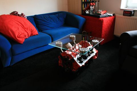 1973 Ford Ranchero - A V8 engine block with pistons serves as a unique coffee table, complete with a glass top.