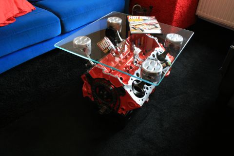 1973 Ford Ranchero - A unique coffee table crafted from a V8 engine block and pistons, topped with a glass surface and a car magazine.