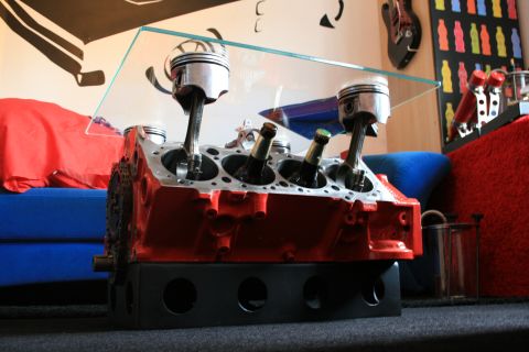 1973 Ford Ranchero - A V8 engine block repurposed as a unique coffee table, complete with pistons and bottles in the cylinders.
