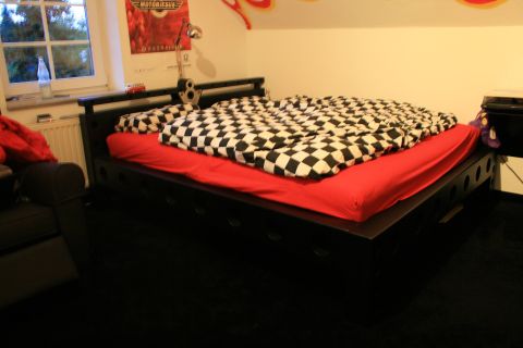 1973 Ford Ranchero - A bedroom decorated with a racing theme, a bed with checkered bedding and posters on the wall.