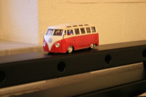 1973 Ford Ranchero - A model of a red and white Volkswagen bus sits on a dark shelf.