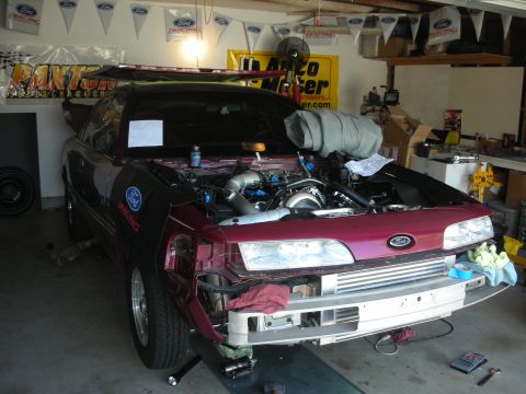 1992 Ford Crown Victoria - 1992 Ford Crown Victoria undergoing engine modifications in a garage setting.