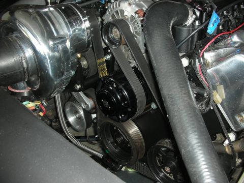 1992 Ford Crown Victoria - Engine bay detail showing a supercharger, alternator, and serpentine belt system.