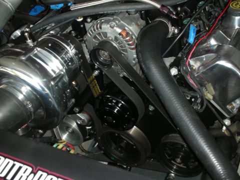 1992 Ford Crown Victoria - Close-up view of an engine bay a polished supercharger and serpentine belt drive system.