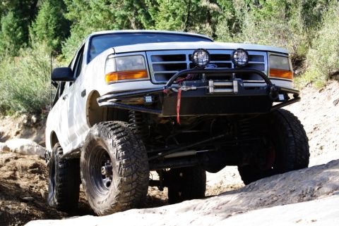 1995 Ford Bronco - Modified 1995 Ford Bronco navigating rough, rocky off-road trail.