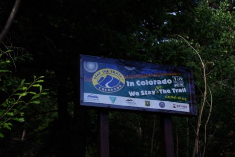 1995 Ford Bronco - A sign in a wooded area encourages people to stay on the trail in Colorado.