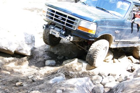 1995 Ford Bronco - This 1995 Ford Bronco is tackling a challenging off-road course with large rocks.