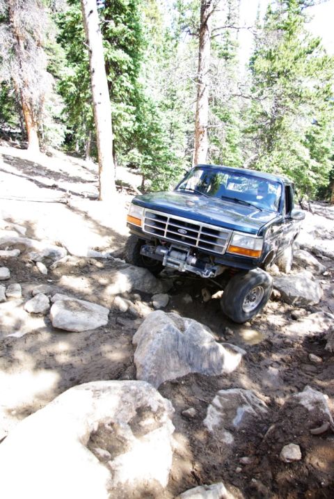1995 Ford Bronco - Ford Bronco tackling rough off-road conditions on a sunny day.