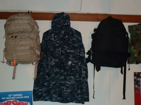 1992 Ford Mustang - Various military-style bags and a U.S. Navy uniform jacket are displayed on a wall.