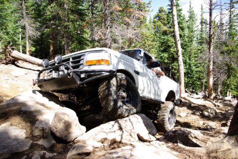 1995 Ford Bronco - This 1995 Ford Bronco tackles a challenging rocky trail with its off-road modifications.