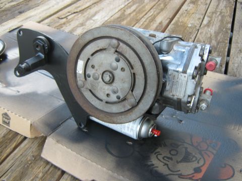 1972 Ford F-250 - This is an AC compressor, likely for a vehicle, shown on a wooden surface.