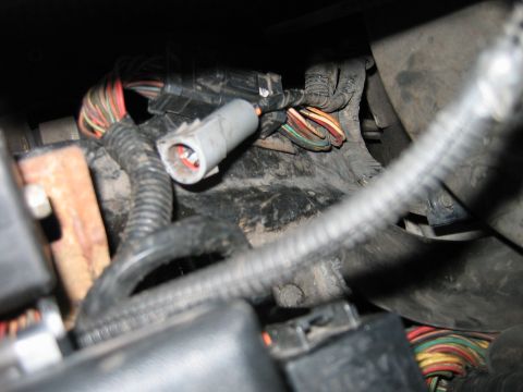 1992 Ford Bronco - A close-up view of a vehicle's complex wiring harness and connectors, showing various colored wires.