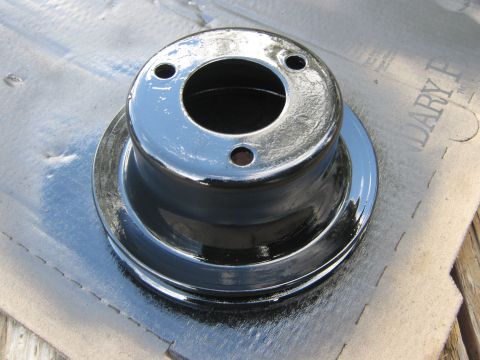 1972 Ford F-250 - A freshly painted pulley rests on a protective paper covering.