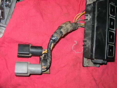 1992 Ford Bronco - Close-up of automotive wiring harness connectors and a fuse box.