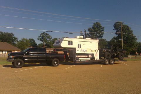 1967 Ford Mustang - Pickup truck hauls camper and jeep on a trailer.